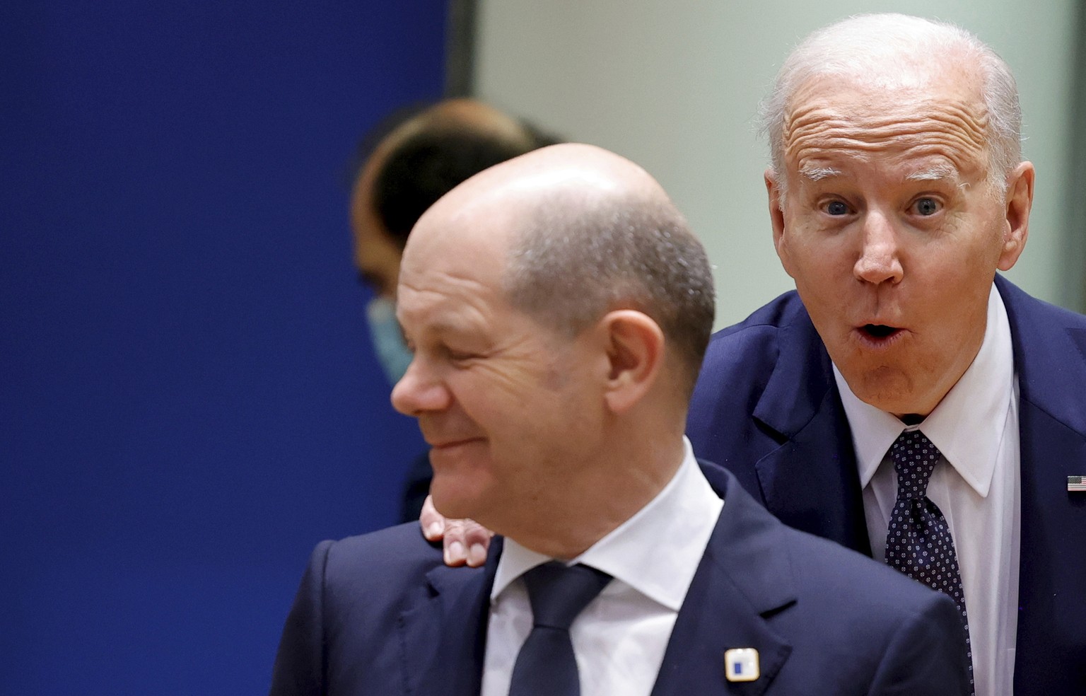 U.S. President Joe Biden, right, puts his hand on the shoulder of German Chancellor Olaf Scholz as he arrives for a round table meeting at an EU summit in Brussels, Thursday, March 24, 2022. As the wa ...