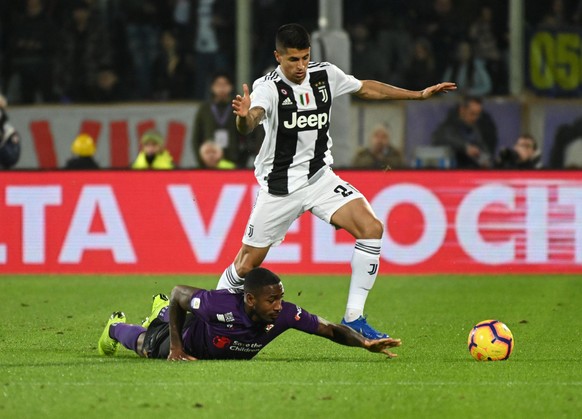 Juventus defender Joao Cancelo runs past Fiorentina midfielder Gerson during the Italian Serie A soccer match between Fiorentina and Juventus at the Artemio Franchi stadium in Florence, Italy, Saturda ...