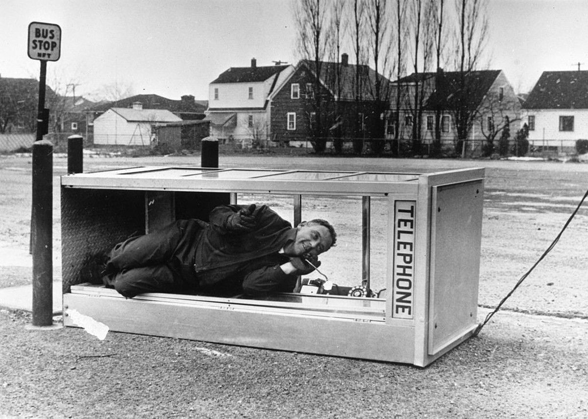 26th September 1967: A man making a call in a blown over telephone box. (Photo by Keystone/Getty Images)