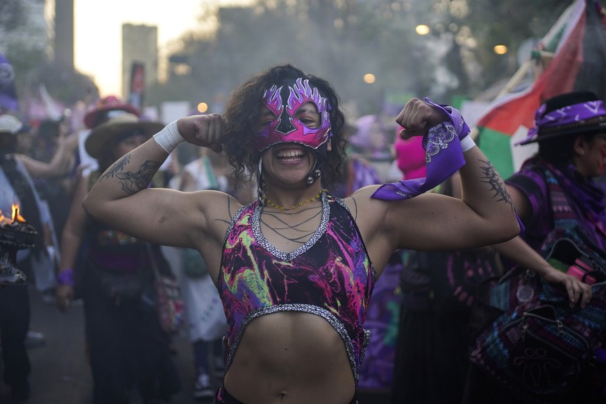 A demonstrator strikes a pose during a march against gender-based violence marking International Women&#039;s Day, in Mexico City, Friday, March 8, 2024. (AP Photo/Aurea del Rosario)