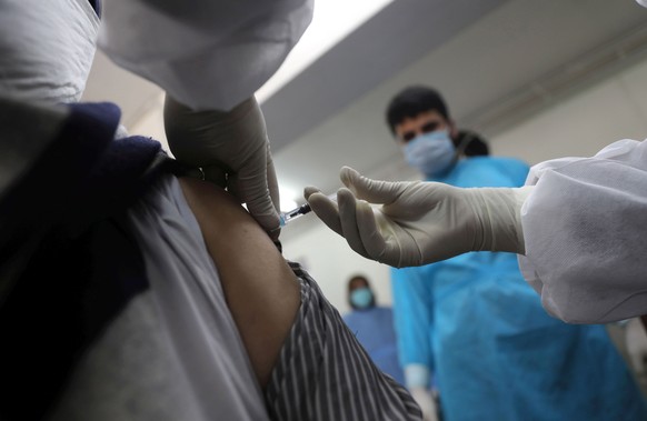 epa09161630 A Kashmiri man receives a shot of a vaccine against COVID-19 during a COVID-19 Vaccination drive in Srinagar, the summer capital of Indian Kashmir, 26 April 2021. In light of the surge in  ...