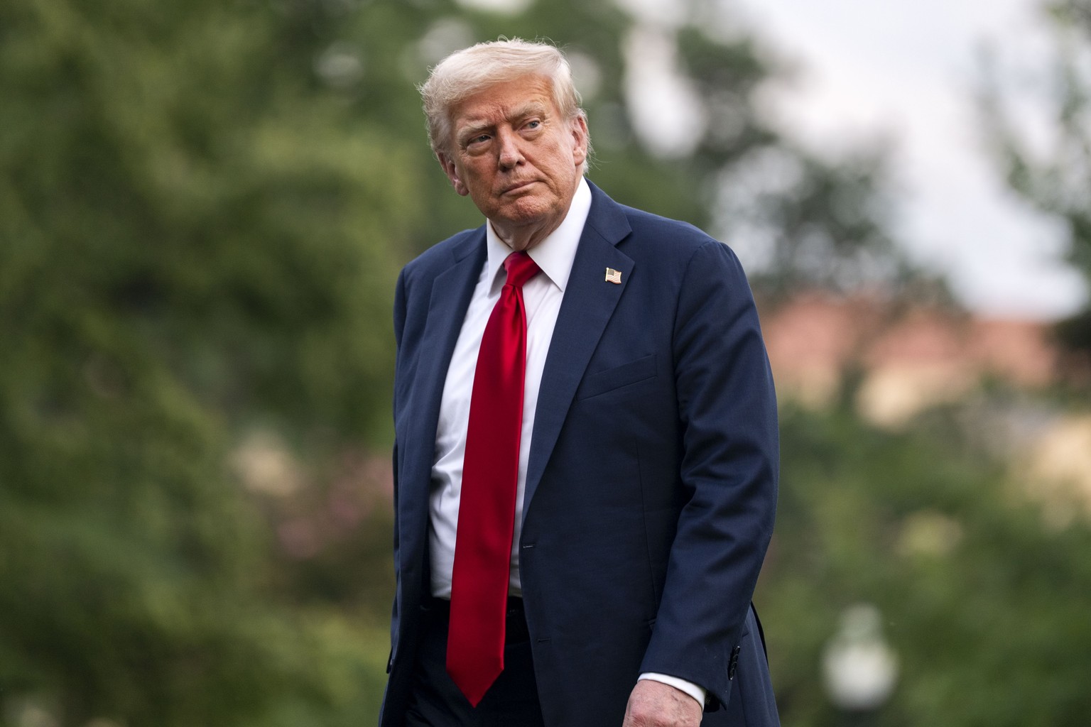 epa12236676 US President Donald Trump looks on after exiting Marine One on the South Lawn of the White House in Washington, DC, USA, 13 July 2025. Trump is returning after attending the FIFA Club Worl ...