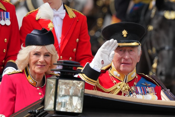 Britain's King Charles III, and Queen Camilla ride in an open top carriage during Trooping The Colour, the King's annual birthday parade, in London, Saturday, June 13, 2026. (AP Photo/Kirsty ...