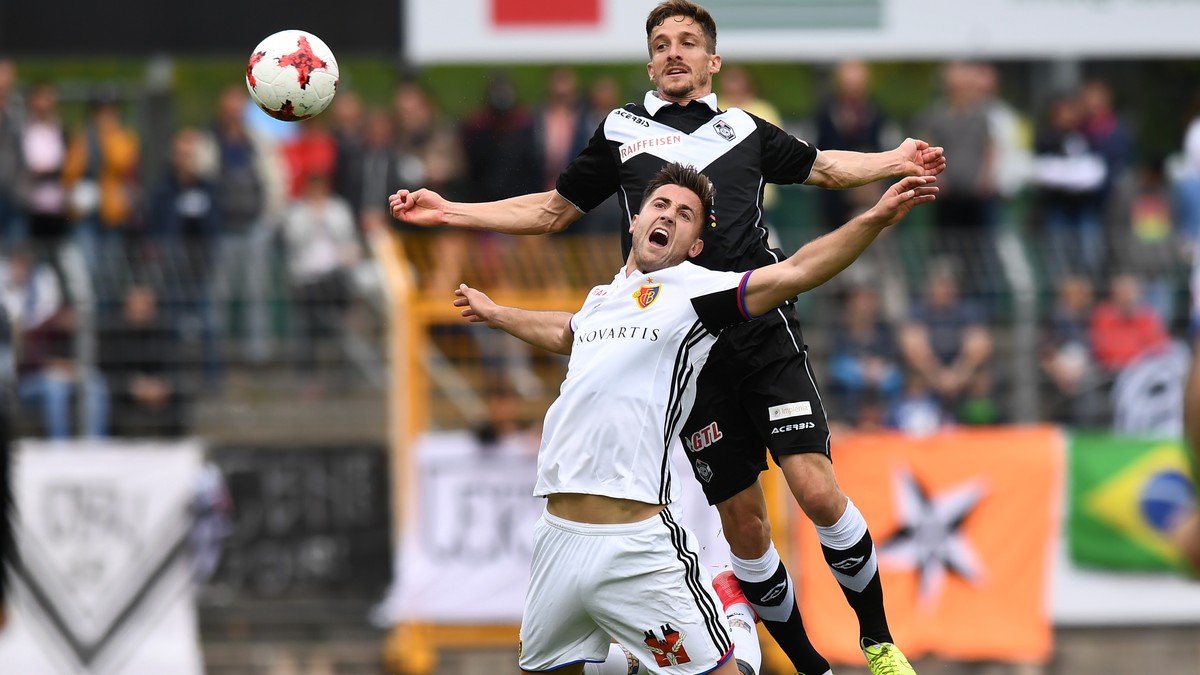 Lugano's player Fulvio Sulmoni, right, fights for the ball with Basel's player Andraz Sporar, left, during the Super League soccer match FC Lugano against FC Basel, at the Cornaredo stadium  ...