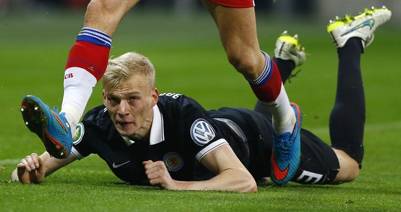 Braunschweig&#039;s Saulo Decarli lies on the ground during the German Soccer Cup round of sixteen match between FC Bayern Munich and Eintracht Braunschweig in Munich, southern Germany, Wednesday, Mar ...