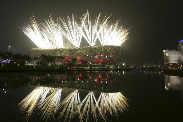 FILE - Fireworks explode during the opening ceremony in the National Stadium at the Beijing 2008 Olympics in Beijing on Aug. 8, 2008. How did Beijing land the Winter Olympics, so soon after it was hos ...