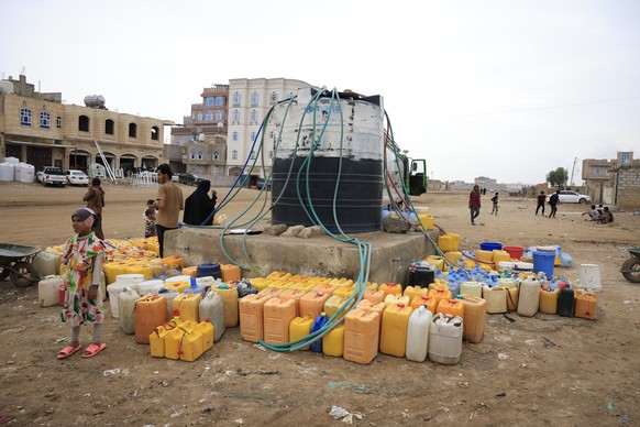 epa12313452 People wait for a water tanker to fill a donated tank amid a water shortage, in Sana'a, Yemen, 20 August 2025. Yemen is one of the most water-scarce countries in the world, with more  ...
