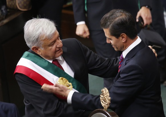 Mexico&#039;s new President Andres Manuel Lopez Obrador and outgoing President Enrique Pena Nieto embrace at the end of the swearing-in ceremony in the lower house chambers of the National Congress, i ...