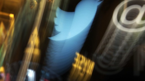 FILE - In this Wednesday Nov. 6, 2013, file photo, the Twitter logo appears on an updated phone post on the floor of the New York Stock Exchange. Twitter says the hackers responsible for a recent high ...