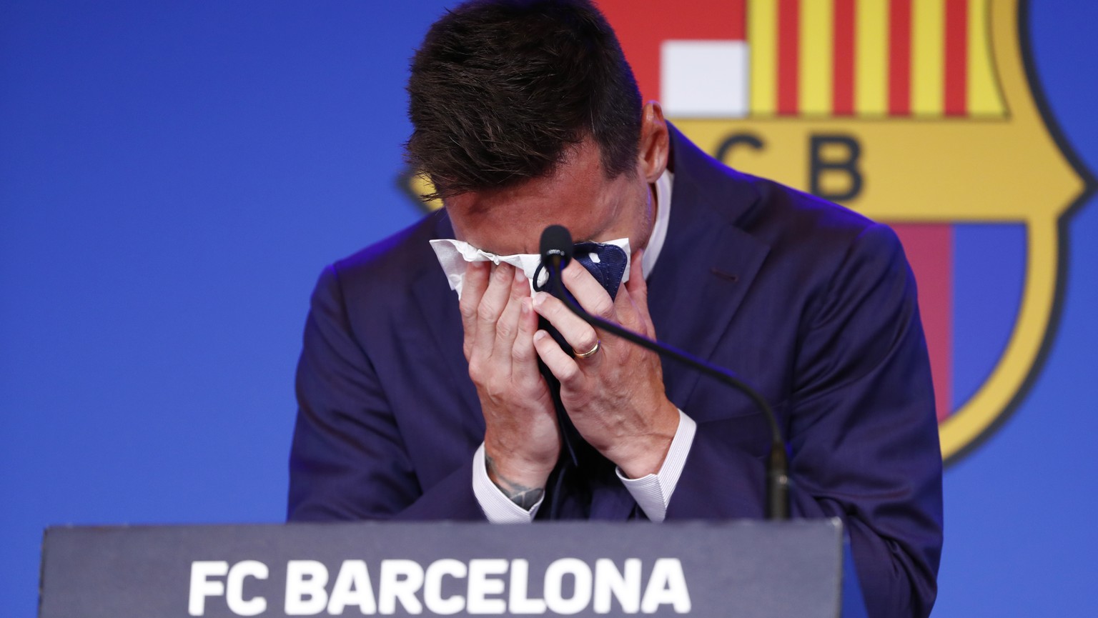Lionel Messi cries at the start of a press conference at the Camp Nou stadium in Barcelona, Spain, Sunday, Aug. 8, 2021. FC Barcelona had previously announced the negotiations with Lionel Messi had en ...