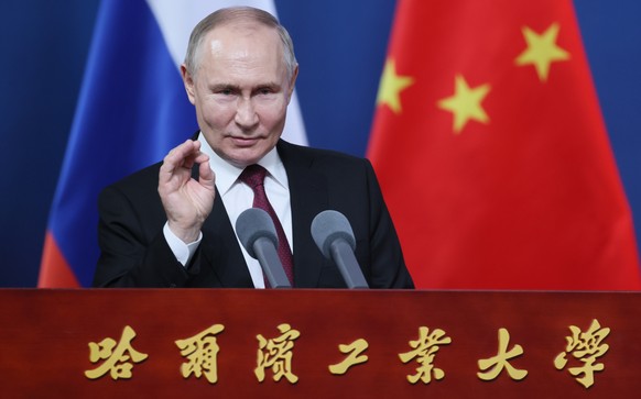 epa11347579 Russian President Vladimir Putin gestures as he delivers a speech during a meeting with students and faculty of the Harbin Institute of Technology in Harbin, Heilongjiang province, China,1 ...