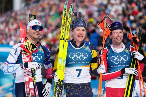 Bronze medalist Emilien Jacquelin, of France, from left, gold medalist Martin Ponsiluoma, of Sweden, and silver medalist Sturla Holm Laegreid, of Norway, pose after the men's 12.5-kilometer pursu ...