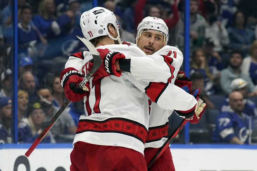 Carolina Hurricanes right wing Nino Niederreiter (21) celebrates with center Jordan Staal (11) after scoring against the Tampa Bay Lightning during the first period of an NHL hockey game Tuesday, Marc ...