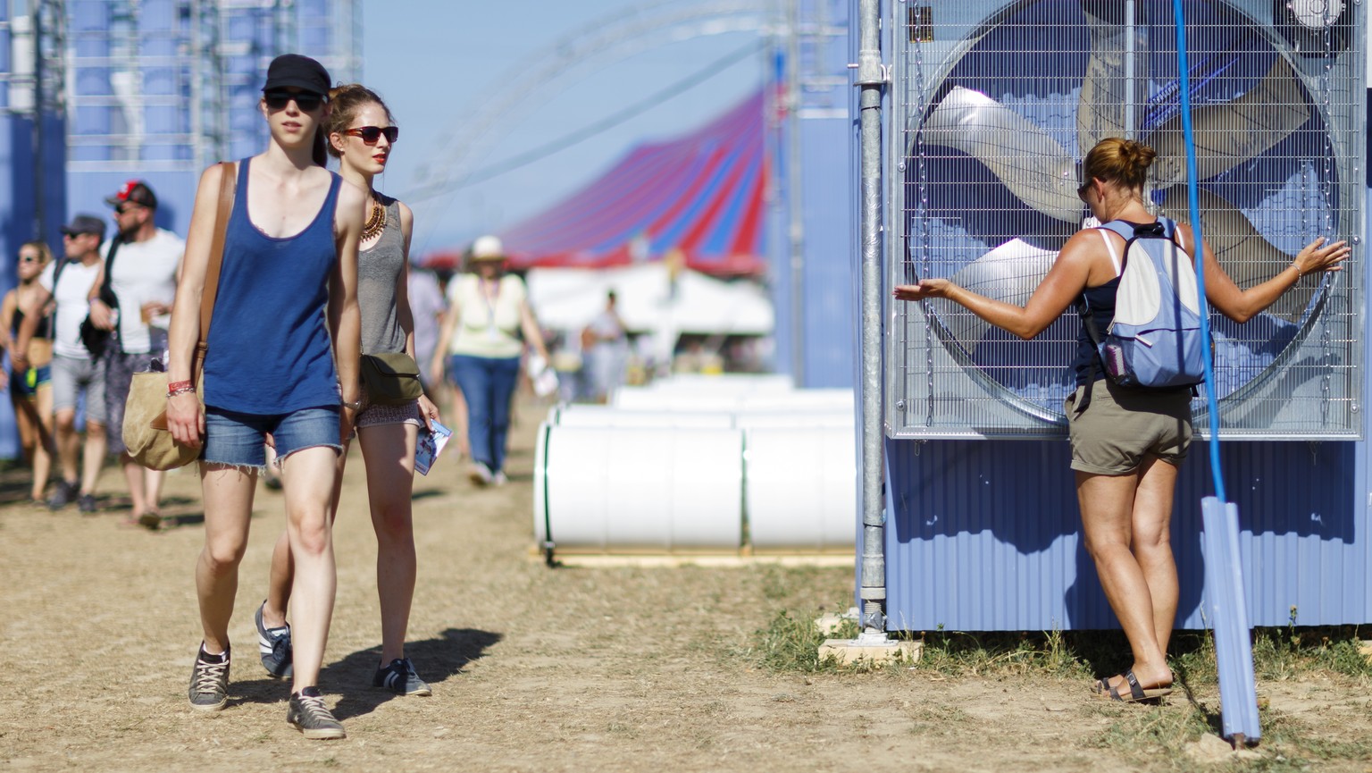 A festival goer cools off in front of a giant fan during the 40th Paleo Festival in Nyon, Switzerland, Tuesday, July 21, 2015. The Paleo open-air music festival, the largest in the western part of Swi ...