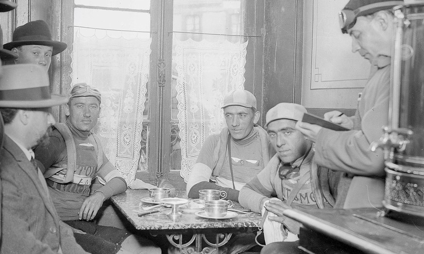 Au Café de la Gare, à Coutances (Manche), Albert Londres (portant chapeau clair, à gauche) interviewe les frères Pélissier (Henri à gauche et Francis à droite) et Maurice Ville après leur abandon, le  ...