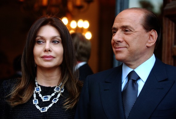 FILE - Italian premier Silvio Berlusconi, right, and his wife Veronica Lario wait for President George W. Bush and first lady Laura Bush at the Villa Madama residence for a social dinner, in Rome June ...