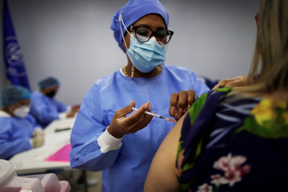 epa09522136 A woman receives the third dose of Pfizer against covid-19 in Panama City, Panama, 13 October 2021. Luis Francisco Sucre, Panama&#039;s Minister of Health, announced on 12 October that Pan ...