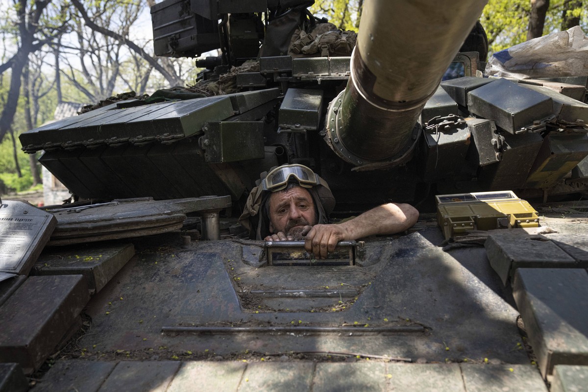 A Ukrainian serviceman enters a tank during the repair works after fighting against Russian forces in Donetsk region, eastern Ukraine, Wednesday, April 27, 2022. (AP Photo/Evgeniy Maloletka)