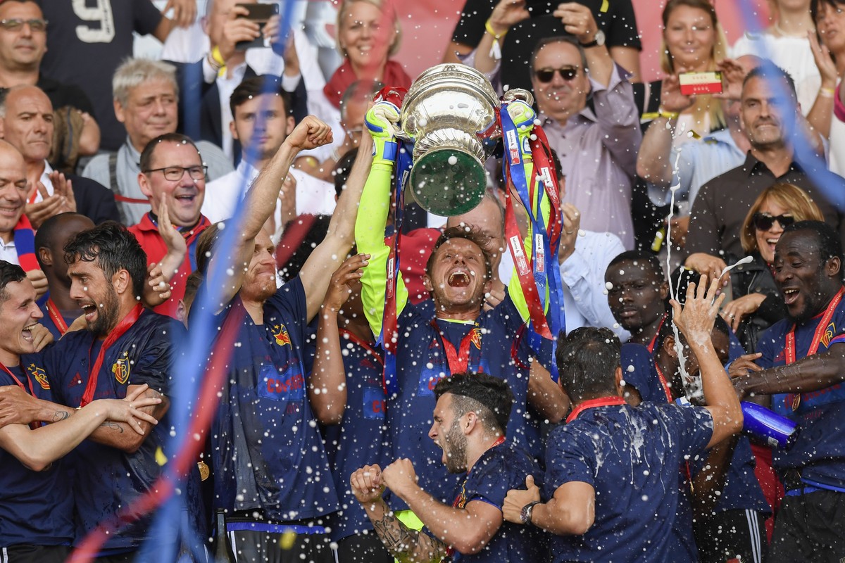 Basel's players celebrate with the trophy after winning the Swiss Cup final soccer match between FC Basel 1893 and FC Sion at the stade de Geneve stadium, in Geneva, Switzerland, Thursday, May 25 ...