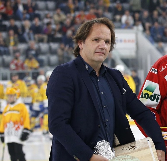 Bill Forster's player is honored before the game for his 1,000th National League game by EHCB General Manager Martin Steininger, left, and League Director Denis Faucher, right, in front of the ice hockey team...