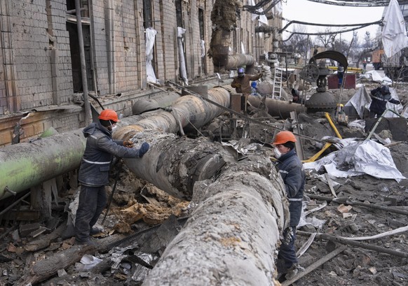 epa12704665 Ukrainian workers repair pipes at a compound of Darnytsia Thermal Power Plant which was damaged by recent Russian missile and drone strikes in Kyiv, Ukraine, 04 February 2026, amid the ong ...