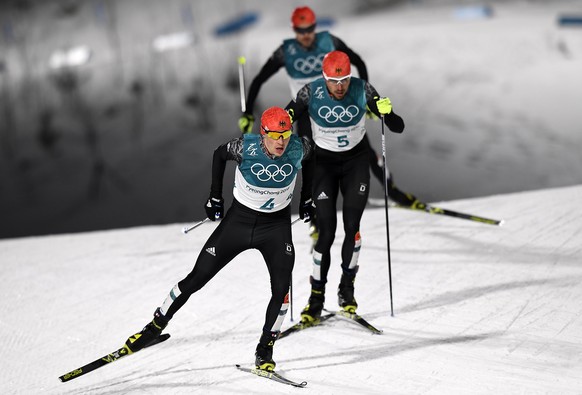epa06546041 (front - back) Erik Frenzel, Fabian Riessle and Johannes Rydzek of Germany in action during the Cross Country portion of the Nordic Combined Individual Large Hill / 10 km competition at th ...