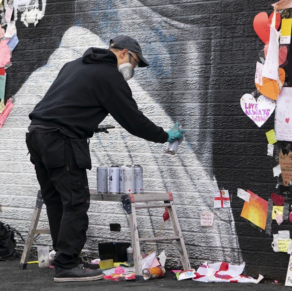 Street artist Akse P19 repairs the mural of Manchester United striker and England player Marcus Rashford on the wall of the Coffee House Cafe on Copson Street, in Withington, Manchester, England, Tues ...