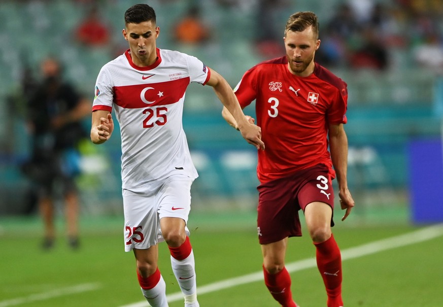 epa09288956 Mert Muldur of Turkey in action against Silvan Widmer (R) of Switzerland during the UEFA EURO 2020 group A preliminary round soccer match between Switzerland and Turkey in Baku, Azerbaijan ...