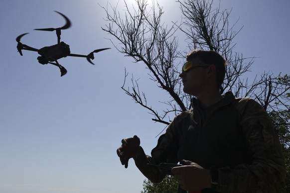 epa12337280 A handout photo made available by the 65th Separate Mechanised Brigade of Ukrainian Armed Forces shows servicemen of the 65th Separate Mechanised Brigade hold their training with drones be ...