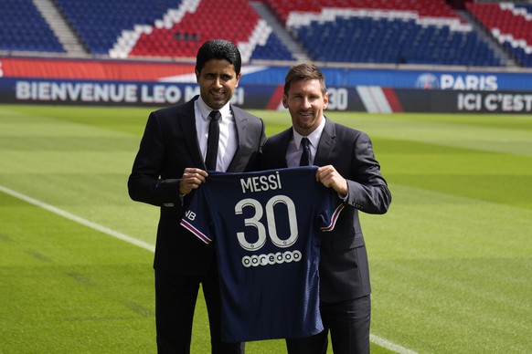 Lionel Messi, right, and PSG president Nasser Al-Al-Khelaifi hold Messi&#039;s jersey Wednesday, Aug. 11, 2021 at the Parc des Princes stadium in Paris. Lionel Messi said he&#039;s been enjoying his t ...