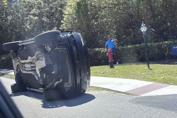 Golfer Tiger Woods stands by his overturned vehicle in Jupiter Island, Fla., on Friday, March 27, 2026. (AP Photo/Jason Oteri)
APTOPIX Tiger Woods Crash Golf