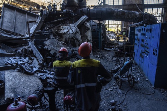 Workers stand among debris in a damaged DTEK thermal power plant after a Russian attack in Ukraine, Thursday, May 2, 2024. Ukrainian energy workers are struggling to repair the damage from intensifyin ...