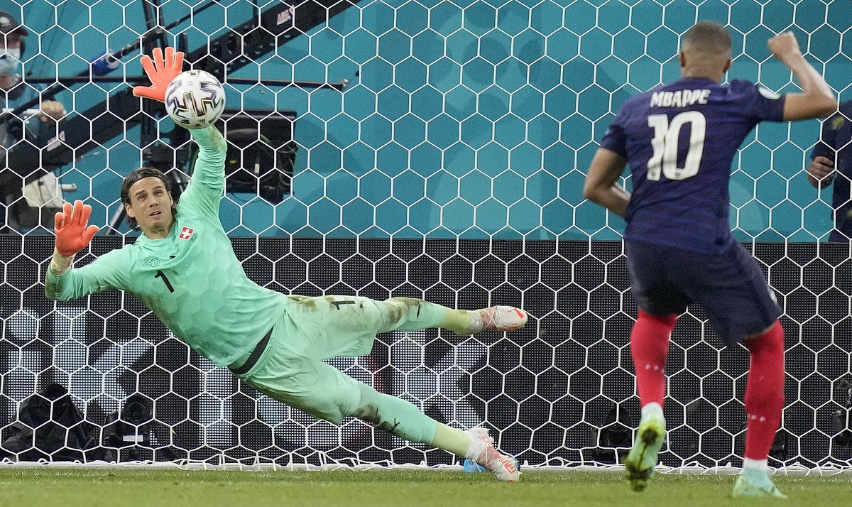Switzerland's goalkeeper Yann Sommer saves the penalty shot by France's Kylian Mbappe during the Euro 2020 soccer championship round of 16 match between France and Switzerland at the Nationa ...