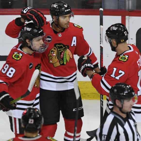 Chicago Blackhawks&#039; Seth Jones (4) celebrates with teammates Nick Foligno (17) and Connor Bedard (98) after scoring a goal during the second period of an NHL hockey game against the Anaheim Ducks ...