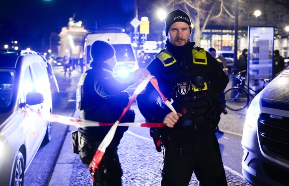 Police officers attend the scene at the Holocaust memorial after a man was attacked at the memorial site in Berlin, Germany, Friday, Feb. 21, 2025. (AP Photo/Ebrahim Noroozi)