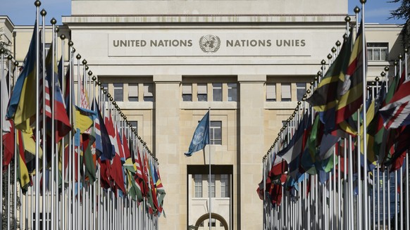 epa05139740 Flags are seen in front of the Palais des Nations during Syria peace talks, at the European headquarters of the United Nations in Geneva, Switzerland, 02 February 2016. UN Syria envoy Staf ...