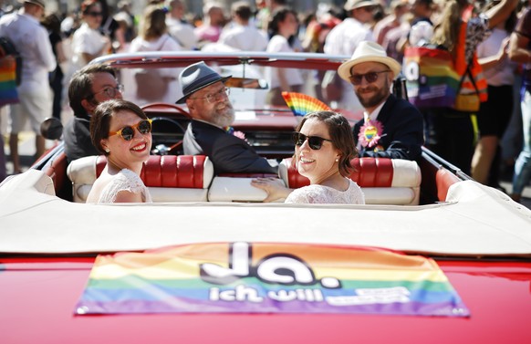 People demonstrate at the Zurich Pride parade in Zurich, Switzerland, with the slogan &quot;Dare. Marriage for all, now!&quot; (Trau Dich. Ehe fuer alle. Jetzt!) for the rights of the LGBTIQ community ...