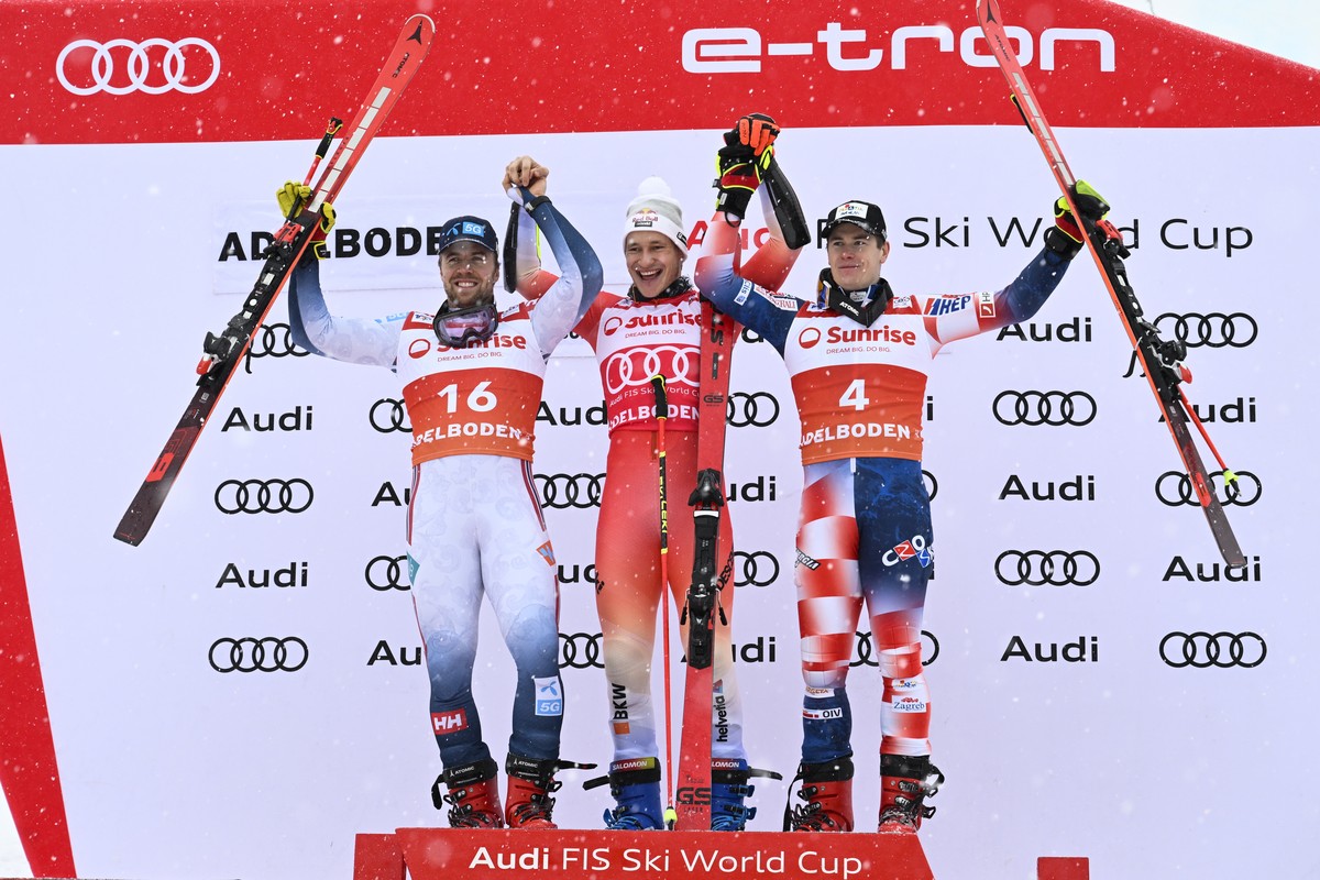 epa11060851 (L-R) second placed Aleksander Aamodt Kilde of Norway, winner Marco Odermatt of Switzerland and third placed Filip Zubcic of Croatia celebrate on the podium for the Men's Giant Slalom ...
