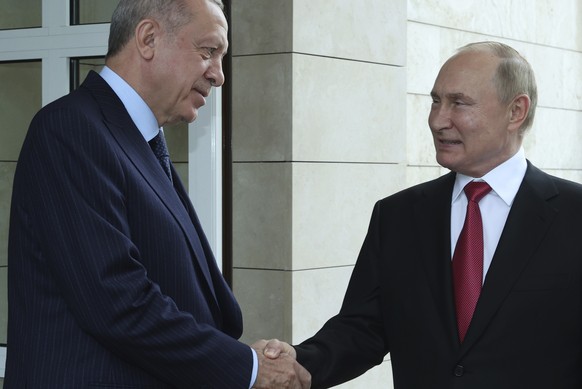 Russian President Vladimir Putin, right, and Turkish President Recep Tayyip Erdogan speak as Erdogan leaves after their talks at the Bocharov Ruchei residence in the Black Sea resort of Sochi, Russia, ...