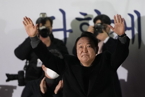 Yoon Suk Yeol, the presidential candidate of the main opposition People Power Party, raises his hands during a presidential election campaign in Seoul, South Korea, Tuesday, March 8, 2022. (AP Photo/L ...