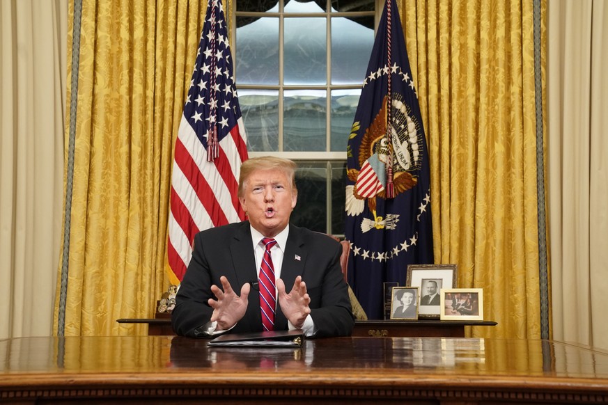 epa07270356 US President Donald J. Trump speaks to the nation in his first-prime address from the Oval Office of the White House in Washington, DC, USA, 08 January 2019. A partial shutdown of the fede ...