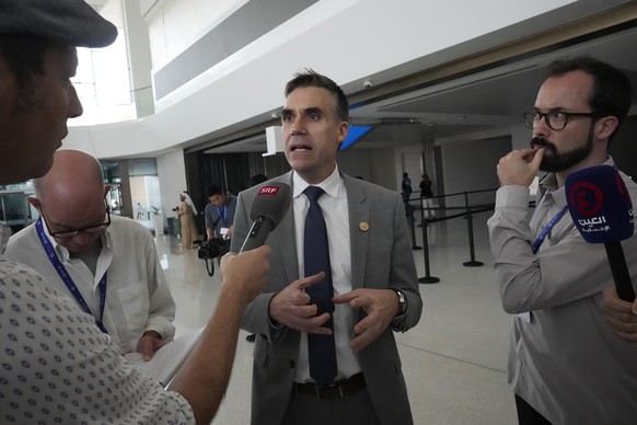 Felix Wertli, Swiss ambassador for the environment, speaks to members of the media after leaving a plenary session at the COP28 U.N. Climate Summit, Wednesday, Dec. 13, 2023, in Dubai, United Arab Emi ...