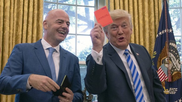Donald Trump Meets Infantino of FIFA United States President Donald J. Trump, right, holds a red penalty card that was presented to him by Gianni Infantino, left, President of Federation International ...