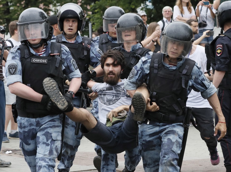 epa07643300 Russian riot police detain a participant of a protest supporting arrested and now released Meduza&#039;s journalist Ivan Golunov suspected in drug keeping and spreading in Moscow, Russia,  ...