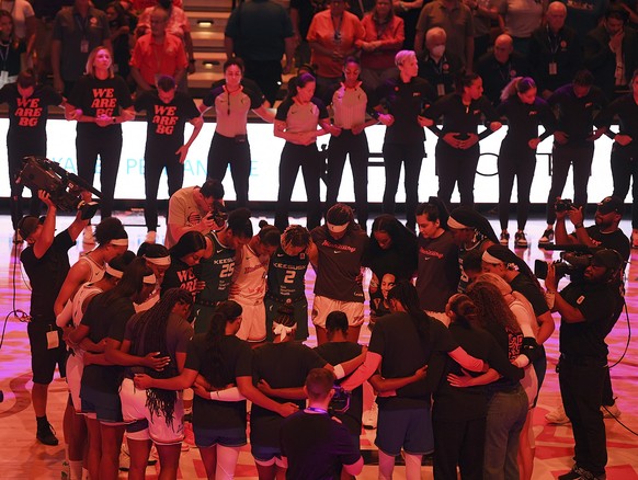 Players with the Connecticut Sun and Phoenix Mercury link arms for 42 seconds in honor of Phoenix Mercury center Brittney Griner before a WNBA basketball game Thursday, Aug. 4, 2022, in Uncasville, Co ...