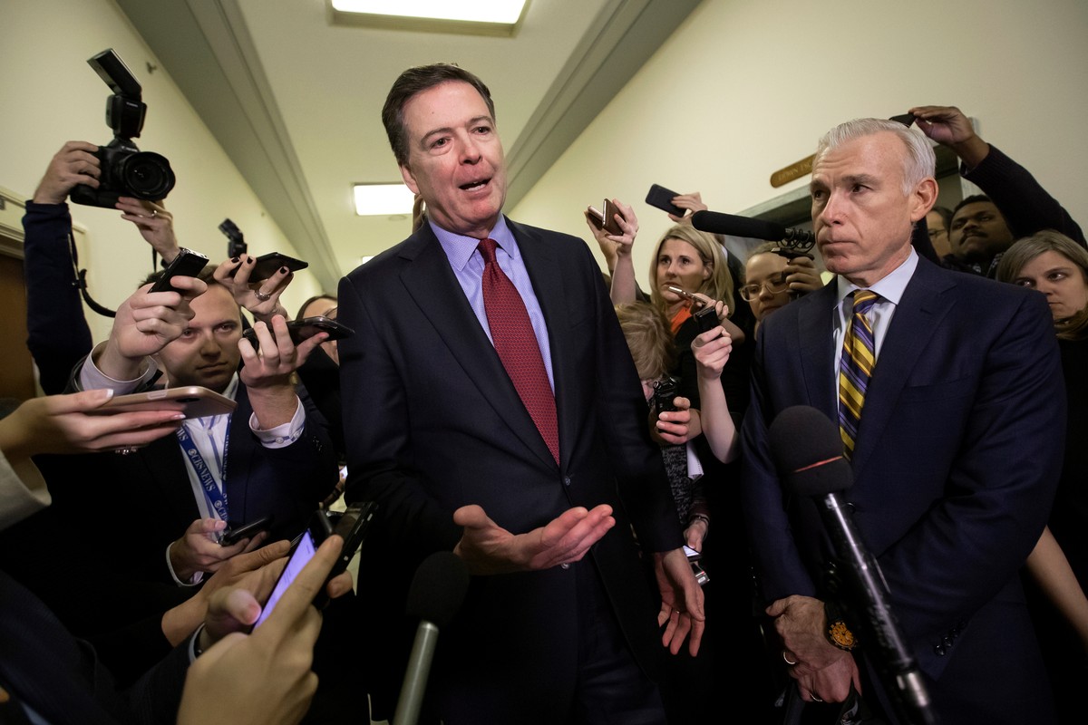 FILE - Former FBI Director James Comey, with his attorney, David Kelley, right, speaks to reporters after a day of testimony before the House Judiciary and Oversight committees, on Capitol Hill in Was ...