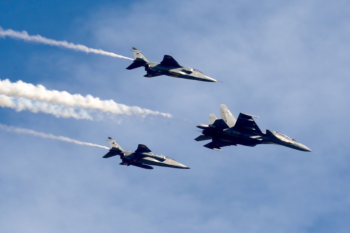 epa10406500 A Russian-made Indian Air Force (IAF) fighter jet Sukhoi Su-30MKI is followed by IAF 'Jaguar' fighter jets developed jointly with Breguet of France, as they fly past during the & ...