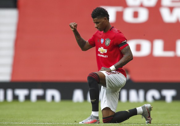 epa08560818 Manchester United&#039;s Marcus Rashford takes a knee to support the Black Lives Matters movement ahead of the English Premier League match between Manchester United and West Ham United in ...