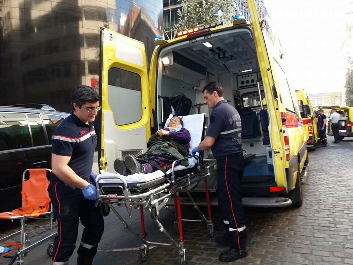 Medics help an injured woman after several people were injured and taken to hospital following clashes between supporters and opponents of the Turkish government outside the country's consulate i ...
