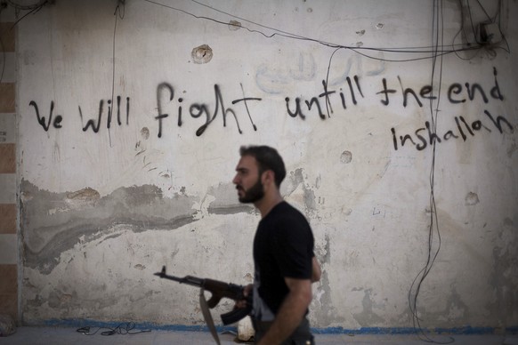 A Free Syrian Army soldier walks through a street in Amariya district in Aleppo, Syria, Monday, Sept. 10, 2012. (AP Photo/Manu Brabo, File)